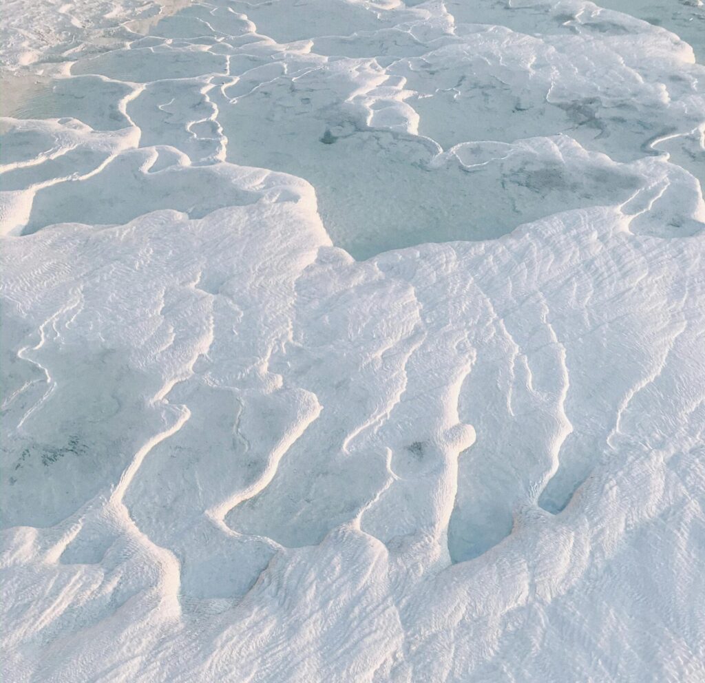 Explore the mesmerizing white terraces with interesting shapes and textures in this captivating aerial landscape.